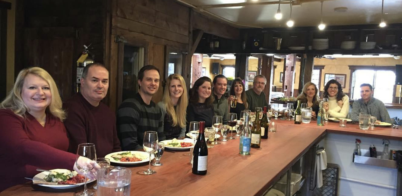 Friends gathered around a long table inside The Steer